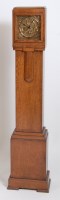 Lot 636 - An Art Deco oak cased grandmother clock,...