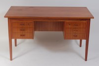 Lot 672 - A 1960s Danish teak kneehole writing desk,...