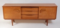 Lot 674 - A 1960s English teak sideboard, having three...