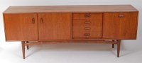 Lot 688 - A 1960s G-Plan teak long sideboard, having...