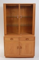 Lot 699 - Ercol - A contemporary blond elm display...