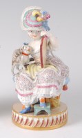 Lot 1027 - A Meissen porcelain figure of a seated girl in...