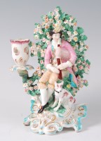 Lot 1056 - A Derby porcelain bocage candle-holder figure...