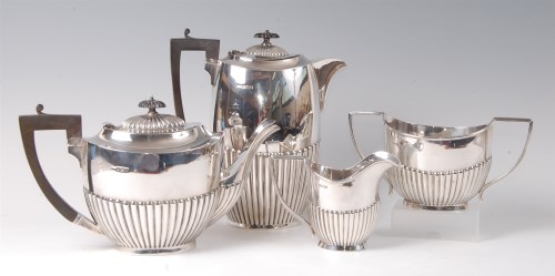 Lot 1079 - An Edwardian large silver four-piece tea and...