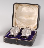 Lot 1109 - A cased pair of George V silver pepperettes,...