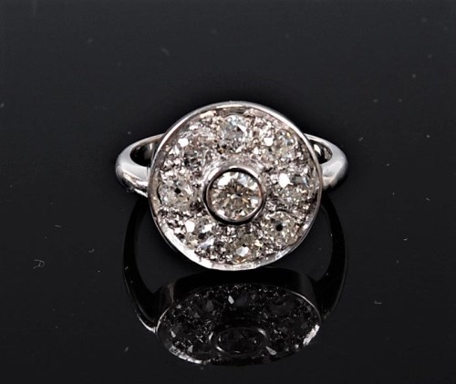 Lot 1124 - An 18ct diamond target ring, the central round...