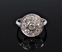 Lot 1124 - An 18ct diamond target ring, the central round...