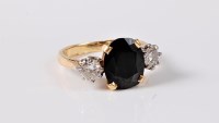 Lot 1138 - A sapphire and diamond ring, the oval sapphire...