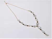Lot 1141 - An aquamarine and sapphire necklace, comprised...