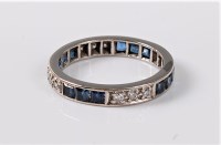 Lot 1152 - A sapphire and diamond eternity ring, the full...