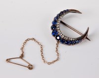 Lot 1155 - A sapphire and diamond crescent brooch, the...