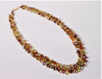 Lot 1159 - A multi gemset necklace, the graduated oval...