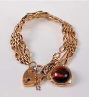 Lot 1160 - An 18ct gatelink bracelet, with heart shaped...
