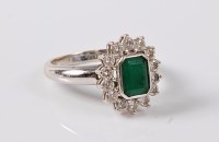 Lot 1168 - An emerald and diamond cluster ring, the...