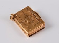 Lot 1175 - A miniature book memorial locket, the engraved...