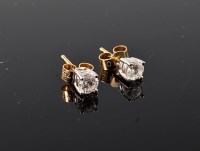 Lot 1178 - A pair of diamond solitaire earstuds, the...