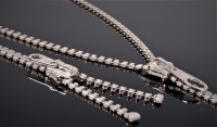 Lot 1191 - A diamond zip necklace and matching bracelet,...