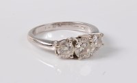 Lot 1200 - An 18ct three stone diamond ring, the three...