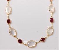 Lot 1207 - A moonstone and ruby necklace, the slightly...