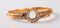 Lot 1211 - A diamond and pearl horseshoe bangle, the...