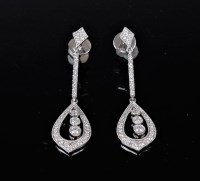 Lot 1214 - A pair of 18ct diamond earrings, the three...