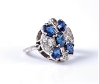 Lot 1225 - A sapphire and diamond dress ring, the central...