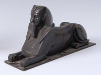 Lot 1245 - An Egyptian Revival bronze Sphinx, on...