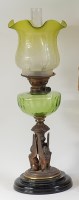 Lot 1262 - A late Victorian bronzed metal oil lamp,...
