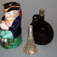 Lot 98 - A Staffordshire toby jug with typical triform...