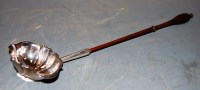 Lot 287 - A George III silver toddy ladle, having walnut...