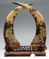 Lot 2 - A pair of large cow horns, each carved with a...