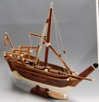 Lot 12 - A scratch-built wooden model of a sailboat