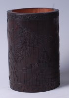 Lot 23 - A Chinese well-carved bamboo brush pot, the...
