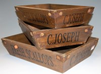 Lot 79 - A graduated set of three stained wooden trays,...