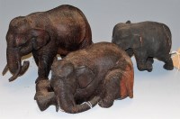 Lot 104 - Three carved and ebonised wooden elephants