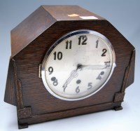 Lot 138 - A 1950s oak cased mantel clock, having a...