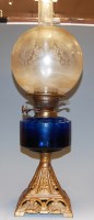 Lot 149 - An early 20th century oil lamp, having etched...