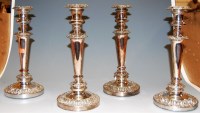 Lot 218 - A set of four silver plated table candlesticks,...
