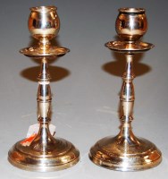 Lot 234 - A pair of George V silver table candlesticks,...