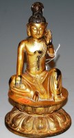 Lot 279 - A gilt bronze figure of a Buddha in seated...