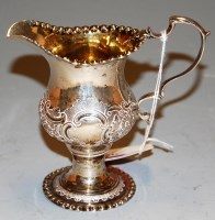 Lot 284 - A George III silver cream jug having repoussee...