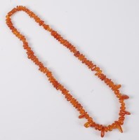 Lot 2522 - An amber bead necklace, the irregular amber...