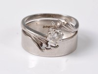 Lot 2528 - A diamond ring and matching wedding band, the...