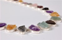 Lot 2529 - A multi gemset and silver necklace, the...