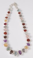 Lot 2529 - A multi gemset and silver necklace, the...