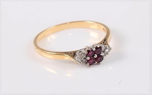 Lot 2549 - An 18ct ruby and diamond ring, the four round...