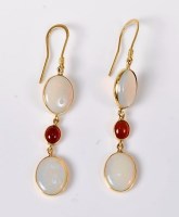 Lot 2554 - A pair of opal and garnet earrings, the oval...