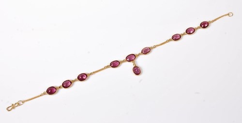 Lot 2560 - A rhodolite garnet bracelet, the oval...