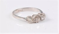 Lot 2564 - A platinum three stone diamond ring, the three...