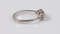 Lot 2564 - A platinum three stone diamond ring, the three...